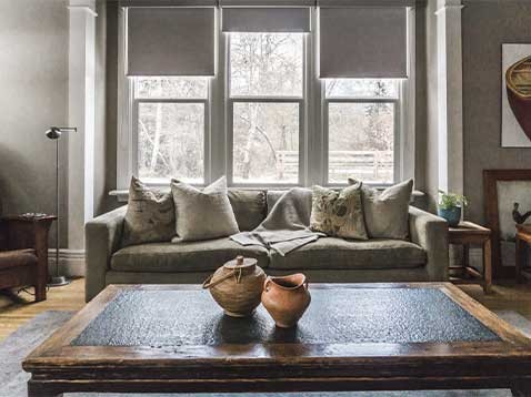 Sitting room showcasing roller shades